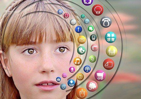 A young girl is surrounded by a circle of social media icons.